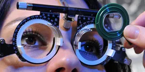 A patient looking through a trial frame with interchangeable lenses